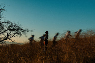 Runner on a high mountain road with peaks behind