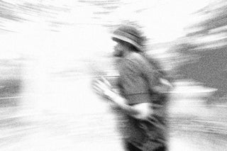 Blurred black and white image of a runner in motion